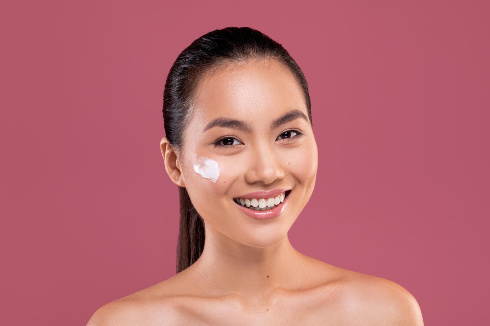 woman-smiling-with-cream-on-her-cheek