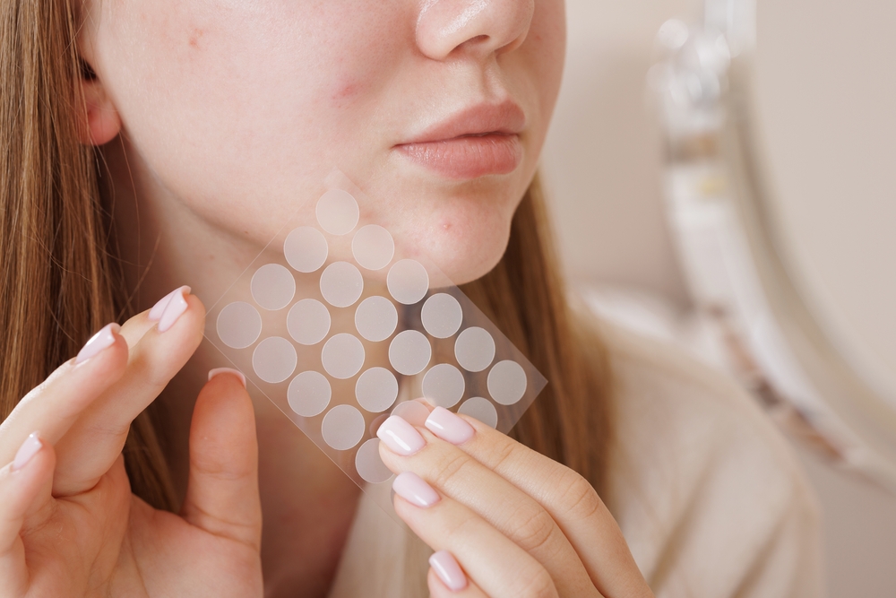 woman-applying-round-pimple-patch-to-face